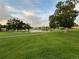 Serene view of the community grounds with pond, lush lawns, and mature trees at 650 S Clinton St # 2A, Denver, CO 80247