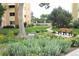 Exterior view of building grounds featuring landscaping, greenery, and a bench at 650 S Clinton St # 2A, Denver, CO 80247