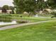 Picturesque pond view with geese, lush greenery, and nearby buildings, offering a tranquil setting at 650 S Clinton St # 2A, Denver, CO 80247