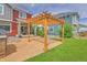 Inviting backyard with a pergola, patio, and green lawn, perfect for outdoor enjoyment at 21900 E 46Th Pl, Aurora, CO 80019