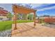 Landscaped backyard featuring a pergola, a built-in grill, and lush green grass at 21900 E 46Th Pl, Aurora, CO 80019
