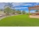 Well-maintained backyard with artificial turf, a built-in grill, and a wooden pergola at 21900 E 46Th Pl, Aurora, CO 80019