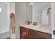 Bathroom with a combination tub and shower with stylish vanity and flower wall decor at 21900 E 46Th Pl, Aurora, CO 80019