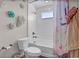 Bright bathroom featuring a shower-tub, decorative flowers, and modern fixtures creates a charming and welcoming space at 21900 E 46Th Pl, Aurora, CO 80019