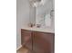 Bathroom featuring a stylish vanity, modern mirror, and charming flower decor on the wall at 21900 E 46Th Pl, Aurora, CO 80019