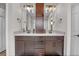 Bathroom featuring a double sink vanity with dark wood cabinets and a large mirror at 21900 E 46Th Pl, Aurora, CO 80019