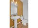 Stylish half-bathroom with a pedestal sink, accent wall and toilet offers a convenient space for guests at 21900 E 46Th Pl, Aurora, CO 80019