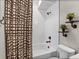 Modern bathroom featuring a shower-tub, decorative plants, and sleek fixtures creates a spa-like space at 21900 E 46Th Pl, Aurora, CO 80019
