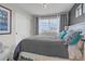 Comfortable bedroom featuring a large window, neutral decor, and accent pillows for a relaxing retreat at 21900 E 46Th Pl, Aurora, CO 80019