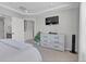 Serene bedroom featuring neutral tones, a dresser, and a ceiling with decorative trim at 21900 E 46Th Pl, Aurora, CO 80019