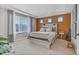 Cozy bedroom featuring a wood accent wall, a large window, and modern furnishings at 21900 E 46Th Pl, Aurora, CO 80019