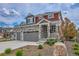 Beautiful two-story home with stone details, three-car garage, and appealing front yard landscaping at 21900 E 46Th Pl, Aurora, CO 80019