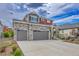 Charming exterior of a two-story home featuring stone accents and a spacious three-car garage at 21900 E 46Th Pl, Aurora, CO 80019
