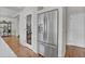 Stainless steel refrigerator with water dispenser next to a pantry with glass door, all in a home with stylish hardwood flooring at 21900 E 46Th Pl, Aurora, CO 80019