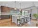 Modern kitchen with a large island, pendant lighting, and stainless steel appliances at 21900 E 46Th Pl, Aurora, CO 80019