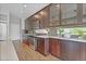 Contemporary kitchen with stainless steel appliances, dark wood cabinets, and hardwood floors at 21900 E 46Th Pl, Aurora, CO 80019