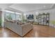 Open living room with hardwood floors, a cozy gray sofa, and lots of natural light at 21900 E 46Th Pl, Aurora, CO 80019