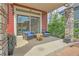 Cozy covered patio featuring stone columns, seating, and a sliding glass door entrance at 21900 E 46Th Pl, Aurora, CO 80019