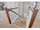 Carpeted staircase with white railings and wood accents leads to the upper level of the home at 21900 E 46Th Pl, Aurora, CO 80019