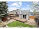 A beautiful backyard with a wooden deck, pergola, and a well-maintained lawn, perfect for outdoor entertaining at 7767 Elmwood St, Littleton, CO 80125