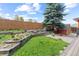 This fenced backyard has a garden, shed, and green space at 7767 Elmwood St, Littleton, CO 80125
