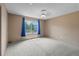 A bedroom with neutral carpet, a ceiling fan, and a window overlooking the outside at 7767 Elmwood St, Littleton, CO 80125