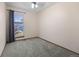 This bedroom has neutral walls, carpeting, and window at 7767 Elmwood St, Littleton, CO 80125
