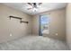 This bedroom features neutral walls, carpeting, and window at 7767 Elmwood St, Littleton, CO 80125