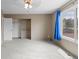 This bedroom features a ceiling fan, closet with shelving, and view of the back yard at 7767 Elmwood St, Littleton, CO 80125