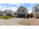 Charming two-story home with a well-manicured lawn, mature trees, and an attached two-car garage at 7767 Elmwood St, Littleton, CO 80125
