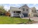 Charming two-story home with a cozy front porch, well-kept lawn, and a two-car attached garage at 7767 Elmwood St, Littleton, CO 80125