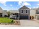 Inviting home exterior with a cozy front porch, well-kept lawn, and a two-car attached garage at 7767 Elmwood St, Littleton, CO 80125