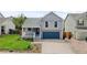 Charming two-story home with a well-manicured front yard and a cozy porch at 7767 Elmwood St, Littleton, CO 80125