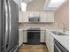 Modern kitchen featuring stainless steel appliances and stylish white cabinetry at 7767 Elmwood St, Littleton, CO 80125