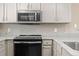 Modern kitchen appliances featuring a GE microwave and black oven range at 7767 Elmwood St, Littleton, CO 80125