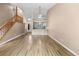Open-concept living area showcasing hardwood floors, a staircase, and a view of the kitchen at 7767 Elmwood St, Littleton, CO 80125