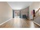 Spacious living room with hardwood floors, fireplace, and sliding glass doors to the yard at 7767 Elmwood St, Littleton, CO 80125