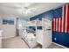Cozy bedroom with a bunk bed and a navy accent wall adorned with an American flag at 10647 Nucla St, Commerce City, CO 80022