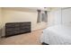 Bedroom featuring carpeted floors, a window with coverings, and a large dresser at 10647 Nucla St, Commerce City, CO 80022