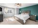 Comfortable bedroom with a large window, a ceiling fan, and stylish furnishings creating a relaxing atmosphere at 10647 Nucla St, Commerce City, CO 80022
