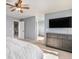 Relaxing bedroom featuring neutral walls, a ceiling fan, and access to an en-suite bathroom and walk-in closet at 10647 Nucla St, Commerce City, CO 80022
