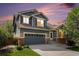 Charming two-story home featuring a two-car garage, brick accents, and professional landscaping at 10647 Nucla St, Commerce City, CO 80022