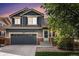Charming two-story home featuring a two-car garage, brick accents, and professional landscaping at 10647 Nucla St, Commerce City, CO 80022
