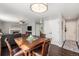 Open concept living and dining featuring hardwood floors and a fireplace at 10647 Nucla St, Commerce City, CO 80022