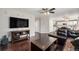 Open concept living room featuring hardwood floors and seamless flow to the kitchen at 10647 Nucla St, Commerce City, CO 80022