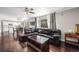 Open concept living room featuring hardwood floors and seamless flow to the kitchen at 10647 Nucla St, Commerce City, CO 80022