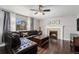 Inviting living room featuring hardwood floors, a fireplace, and a large window at 10647 Nucla St, Commerce City, CO 80022