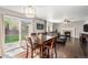 Open concept living and dining featuring hardwood floors and a fireplace at 10647 Nucla St, Commerce City, CO 80022