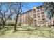Charming brick apartment building with beautiful lawn and mature trees offering a serene outdoor space at 99 S Downing St # 605, Denver, CO 80209