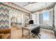 Stylish home office with colorful wallpaper, hardwood floors, and bright window light at 99 S Downing St # 605, Denver, CO 80209